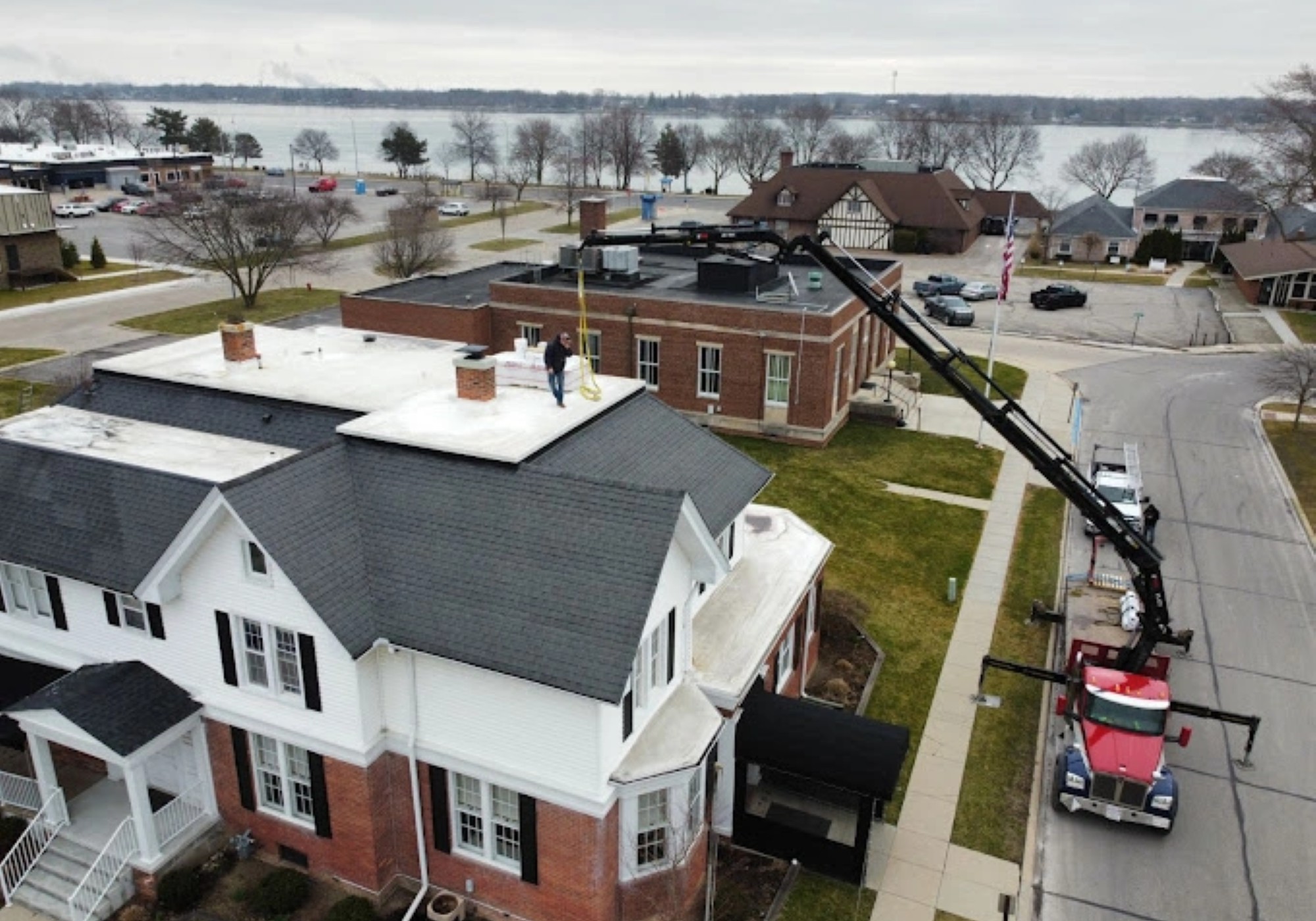 Roof inspection with crane near a lake
