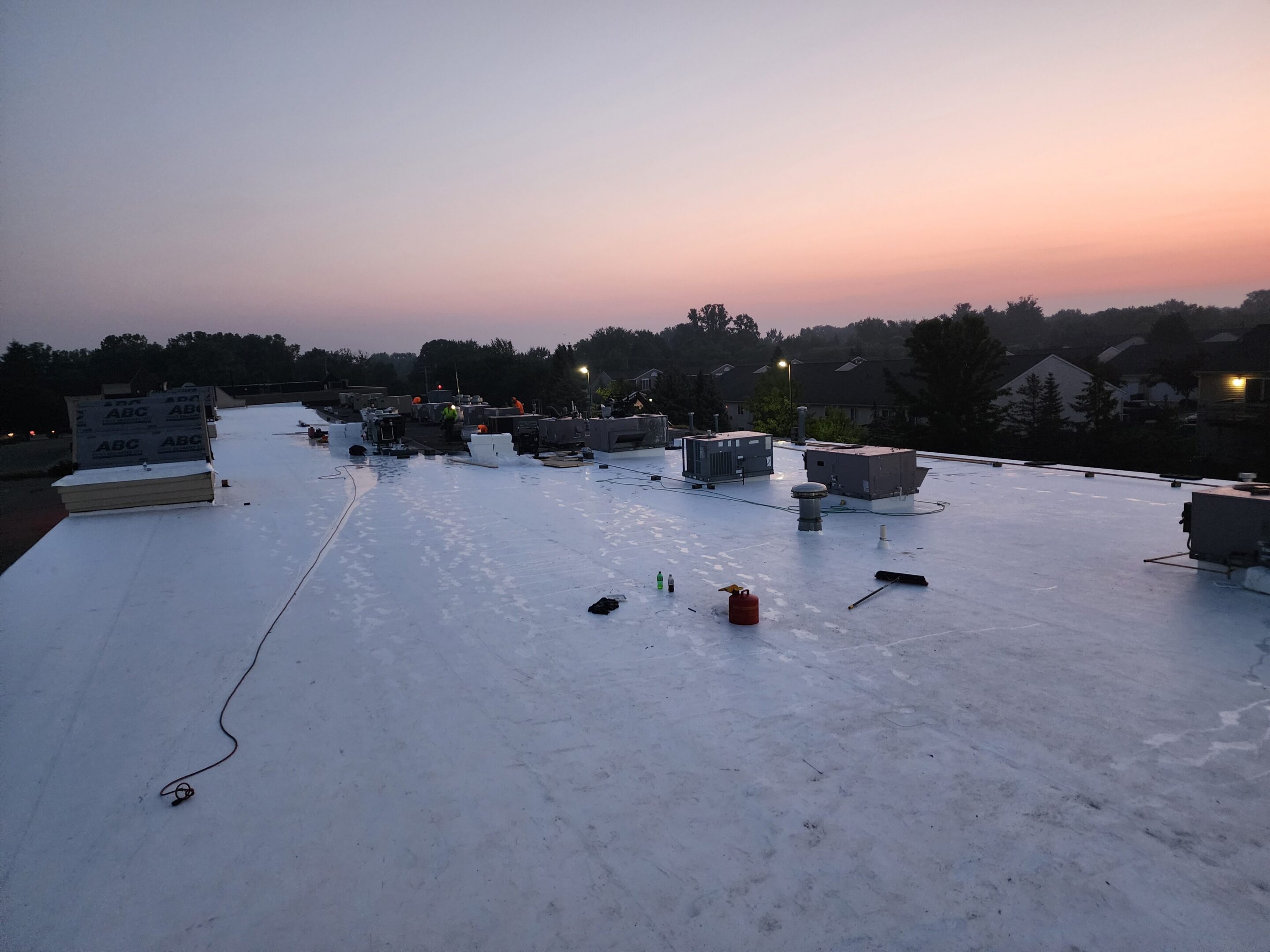 Rooftop at dawn with construction materials.