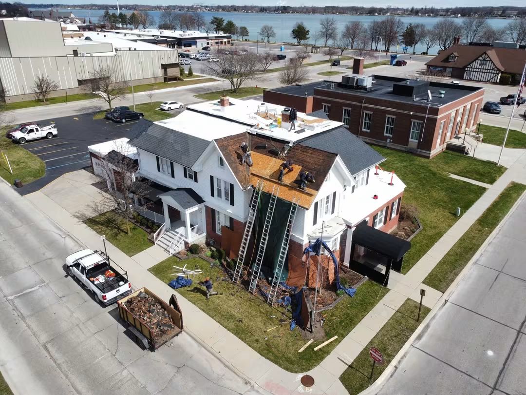 House roof repair in progress, aerial view.