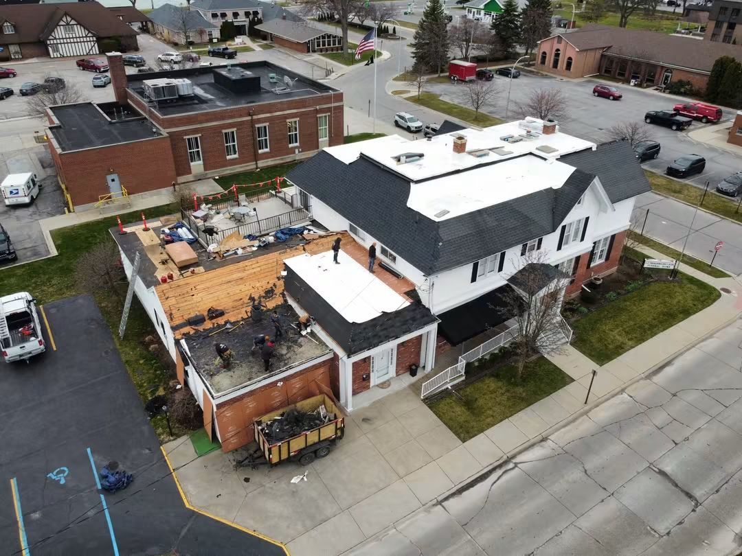 Aerial view of building under roof renovation.